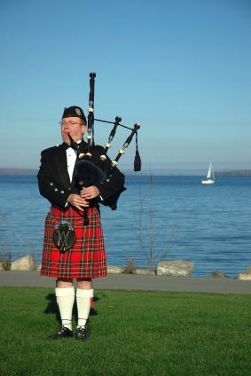 Scottish piper wearing an authentic Scottish kilt
