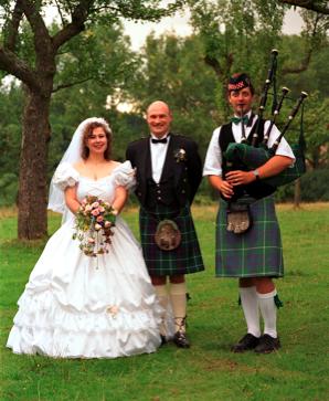 Us and the  piper at our kilt wedding