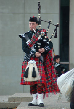 Piper wearing full Highland Dress with full plaid Piper wearing full Highland Dress with full plaid