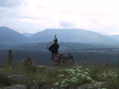 Lone piper in the Scottish hills